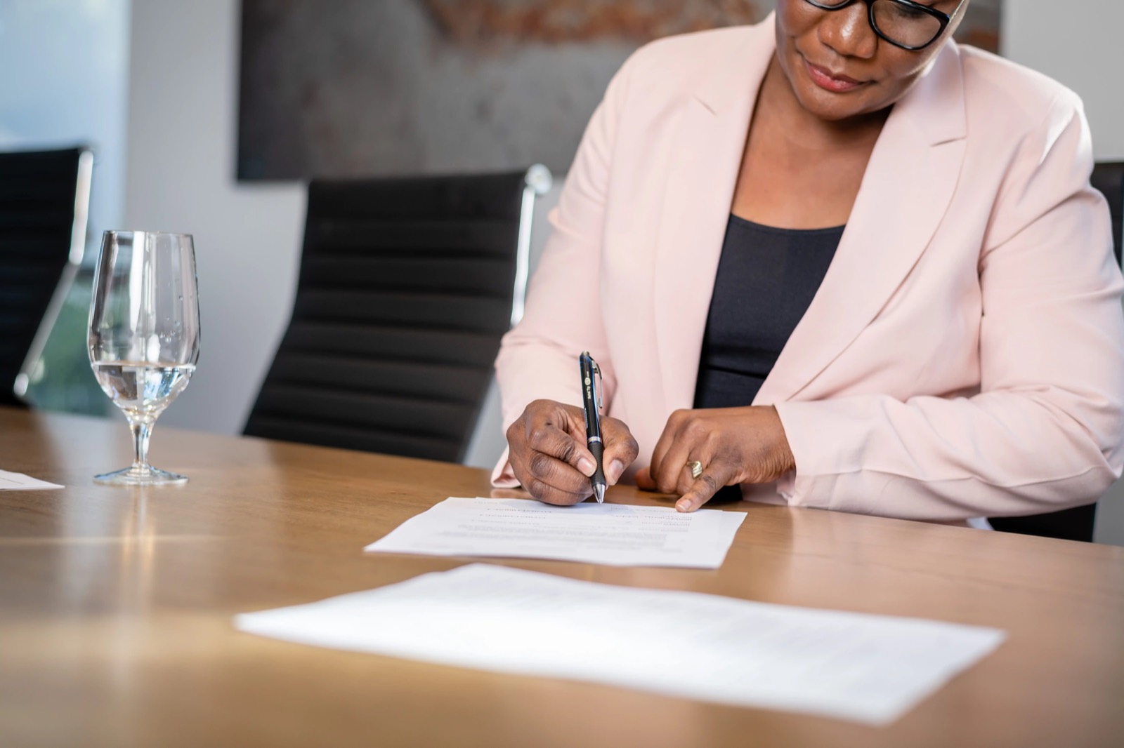 A client signing an engagement document in the Potentia boardroom